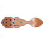 A late 20th Century pierced and carved mahogany welsh love spoon, 7 x 27 cm