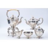 An Edwardian silver five piece bachelor teaset, comprising a spirit kettle, teapot, milk jug, sugar