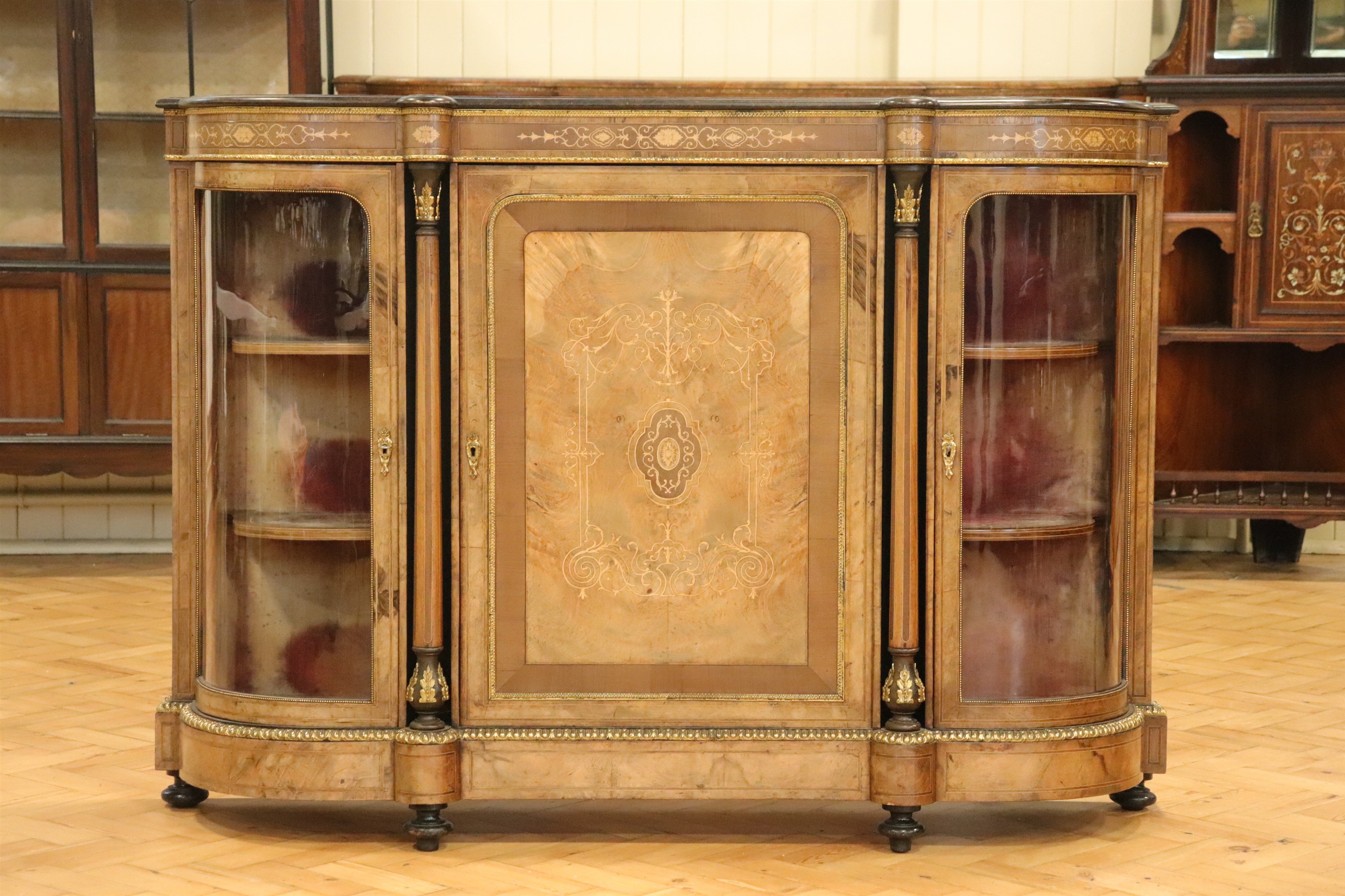 A Victorian gilt metal mounted and inlaid burr walnut veneered credenza, having a book-veneered