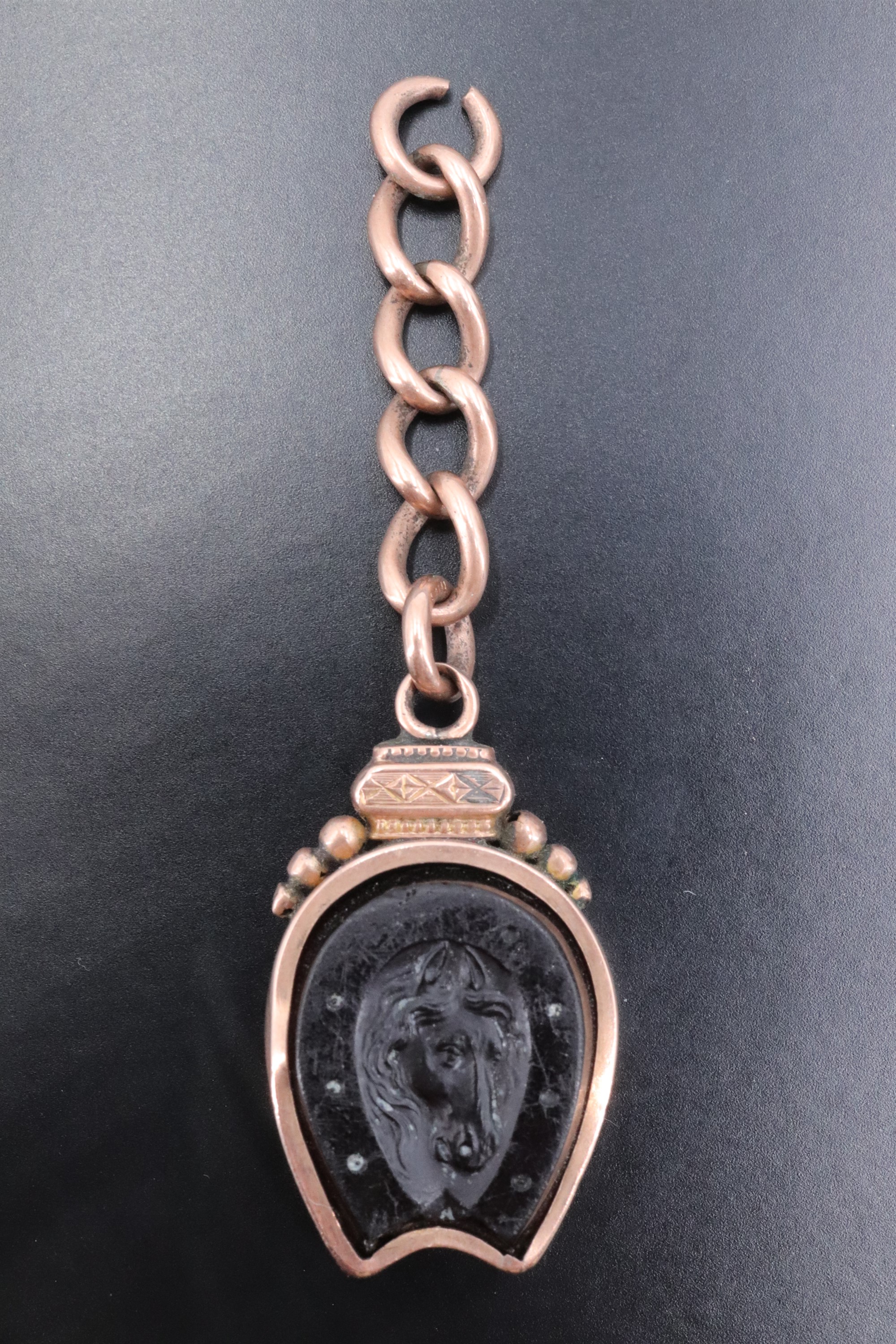 A Victorian 9 ct gold novelty watch chain fob, incorporating a magnetic compass and a relief-