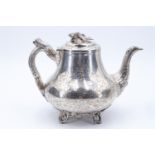 A 19th Century Irish silver teapot, of compressed baluster form having a cast spout and naturalistic