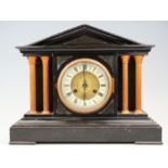 An early 20th Century German faux slate mantle clock, having a Junghans movement, striking on a