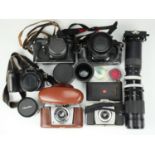 A Canon A-1 camera, Finepix S602 zoom camera, Agfa Silette camera, Kodak vest pocket camera model 3,