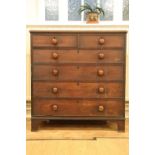 A George III mahogany chest of two short over four long cock-beaded drawers, having square bracket