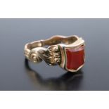 A Victorian carnelian and high carat yellow metal signet ring, having a vacant shield shaped