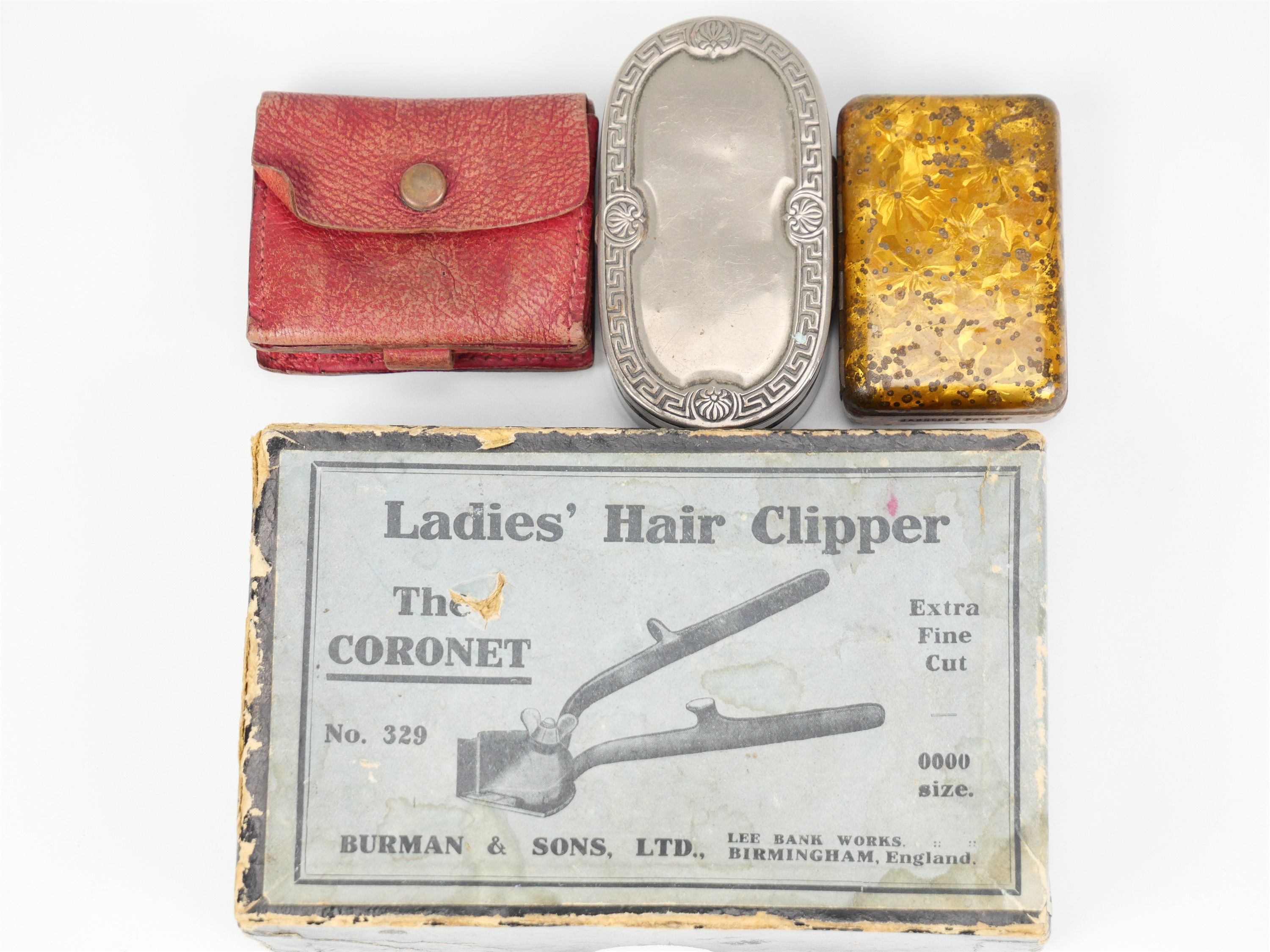 A boxed Burman & Sons "The Coronet" ladies' hair clipper, together with a small coin purse, a
