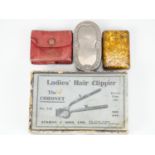 A boxed Burman & Sons "The Coronet" ladies' hair clipper, together with a small coin purse, a