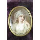 A 19th Century painted porcelain portrait miniature, depicting a veiled young lady, in a velvet