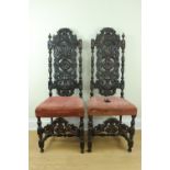 A pair of Victorian reproduction late 17th Century carved oak back stools