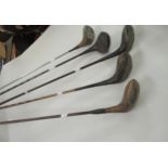 Five various golf clubs with steel and metal shafts There are three with wooden shafts and two are