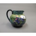 Moorcroft jug decorated with orchids on a mottled blue/green ground, incised signature mark and