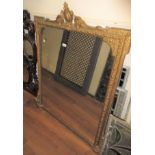 Victorian gilded composition over mantel mirror with a shaped surmount and original plate, 48.5ins x