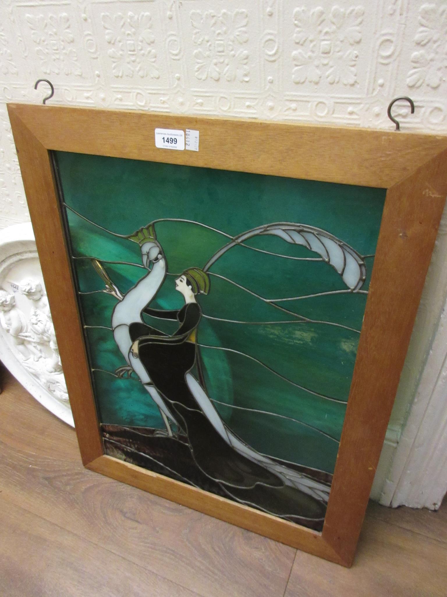 Framed leaded coloured glass panel of a lady and a bird, 22ins x 17ins