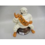 Vintage cast metal Michelin man figure (later painted) and mounted on a wooden stand