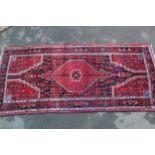 Large Hamadan rug with lobed medallion and all-over design with corner designs in shades of red