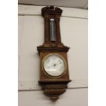 Late 19th / early 20th Century carved oak aneroid barometer thermometer by Negretti & Zambra, in