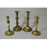 Pair of antique gilt brass circular baluster form candlesticks with visible casting seam, having