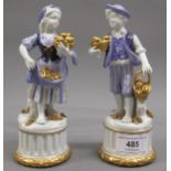 Pair of Naples blue gilt and white decorated porcelain figures of fruit sellers, 7.5ins high