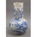 Japanese blue and white baluster form vase, with shaped rim and all over bird and floral decoration,