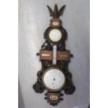 Late 19th / early 20th Century carved walnut aneroid barometer / thermometer with clock and calendar