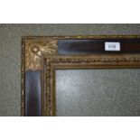 19th / 20th Century partly gilded composition picture frame, having corner leaf and roundel