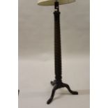 Early 20th Century wrought iron lamp standard, mahogany bed post lamp standard, an oval mahogany