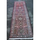 20th Century Karaja runner with repeating hooked medallion design and borders, 8ft x 2.5ft