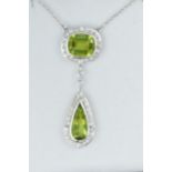 18ct White gold pendant set with a pair of drop peridot and oval cushion cut peridot surrounded by