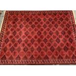 Large good quality machine woven carpet of Turkoman design with multiple rows of gols on a wine