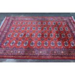 Machine woven rug of Turkoman design, 7ft 4ins x 5ft 8ins approximately, together with a similar