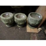 Group of three small cast concrete garden planters