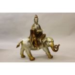 20th Century silvered and gilt patinated bronze figure of a Goddess seated on an elephant, 22.5ins