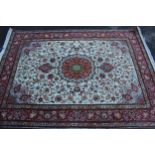 Modern Tabriz rug with a lobed medallion and all over floral design on an ivory ground with borders,