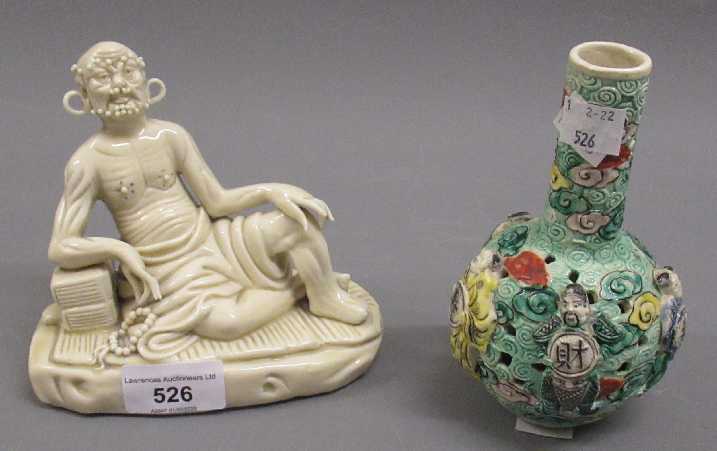 20th Century Oriental porcelain figure of a reclining man, with character marks to back and a