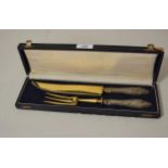 Cased pair of Continental silver handled (800 mark) carvers with gold plated steel blades in a