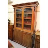 Victorian mahogany bookcase, the moulded cornice above a pair of glazed doors enclosing shelves,