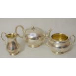 Victorian silver three piece tea service of engraved circular squat baluster form, the tea pot and