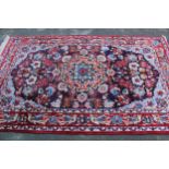 Tabriz rug with a medallion and all-over floral design on a dark ground with borders, 8ft x 4ft