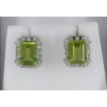 Pair of 18ct white gold emerald cut peridot and diamond stud earrings
