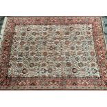 Machine woven carpet of Persian design with an all-over stylised palmette and flower head pattern on