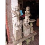 Pair of 20th Century weathered cast concrete figures on square plinth bases