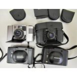 Two Olympus XA cameras together with two Minox cameras and a small quantity of accessories