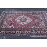 Tabriz rug with a lobed medallion and all-over floral design on a rose ground with multiple borders,