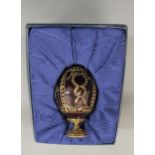 Modern Faberge engraved glass egg with gilded decoration on a brass stand, in original box with