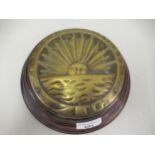 Early P & O circular brass plaque on a wooden base Screwed to the plaque and has patina to lower