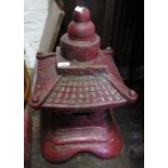 Small red patinated concrete garden pagoda, together with a similar red patinated concrete figure of