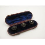 Cased set of three Victorian gold dress studs, set with split pearls and carved bog oak