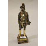 Gilt and silvered patinated bronze figure of a Prussian soldier, on a stepped onyx base, 10.5ins