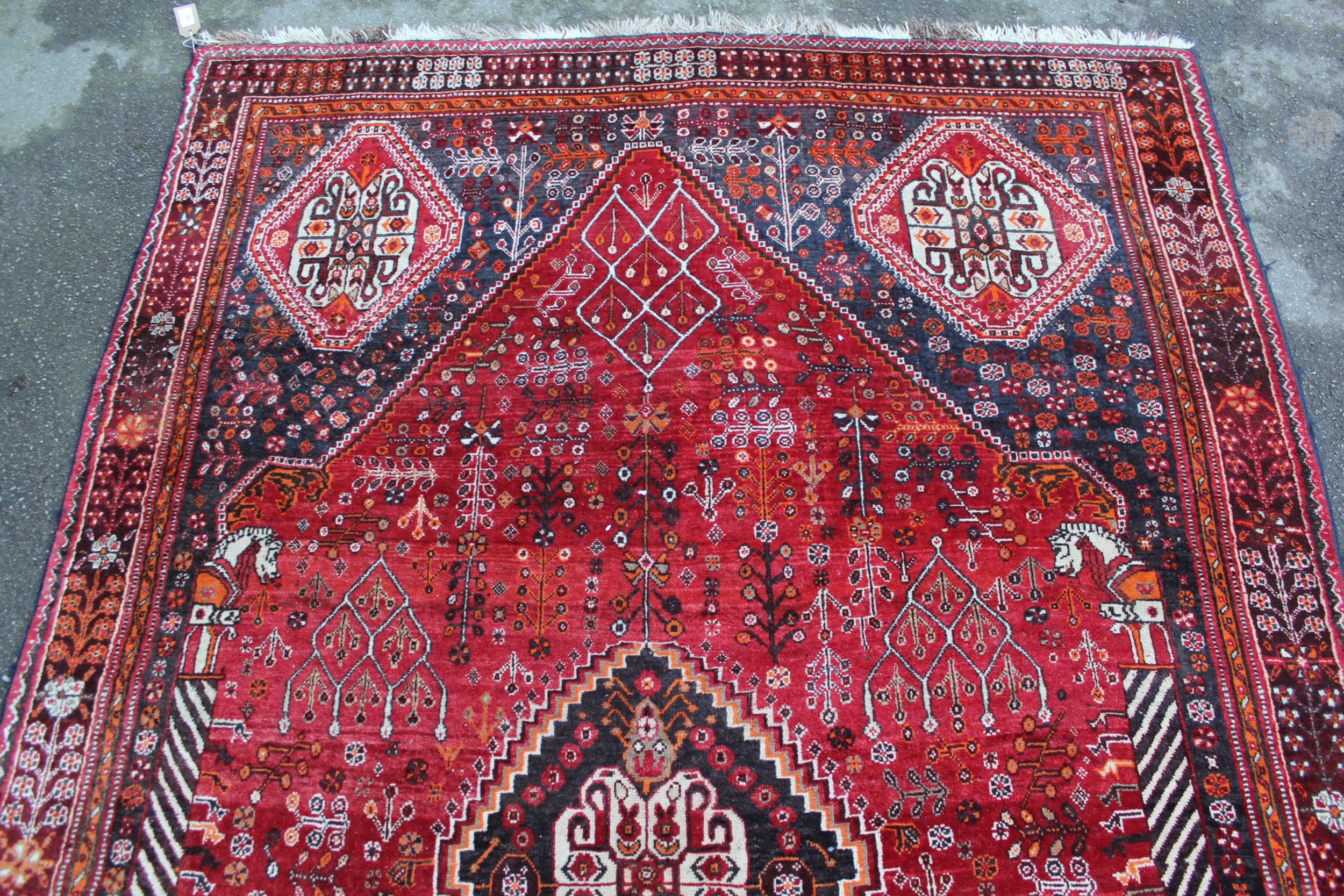 Qashqai rug with central medallion design on red and blue ground with borders, 96ins x 64ins Good - Image 2 of 4