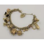 9ct Gold curb link charm bracelet, with multiple charms, 18.5 grams gross weight